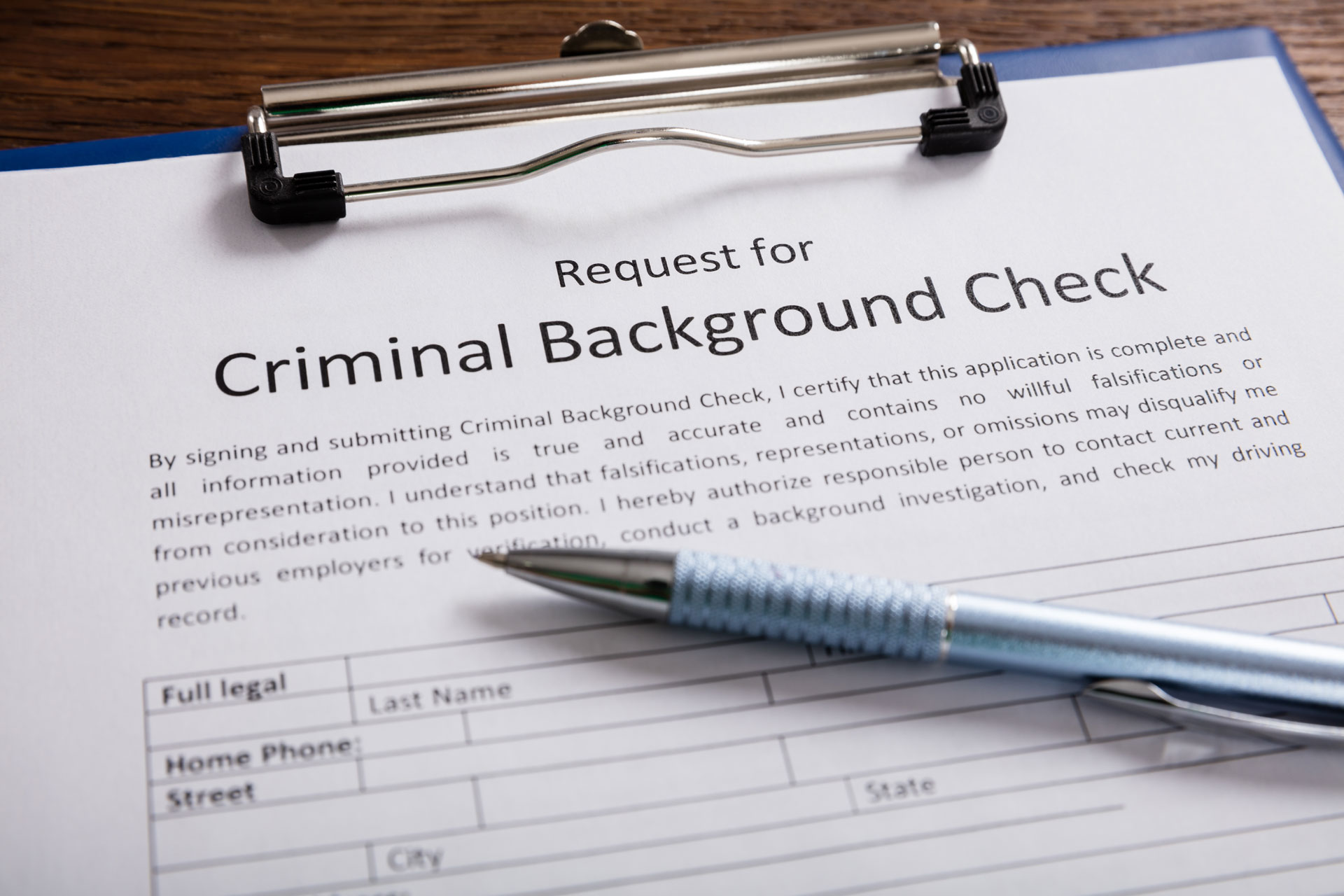 Close-up-Of-Criminal-Background-Check-Application-Form-With-Pen-At-Desk