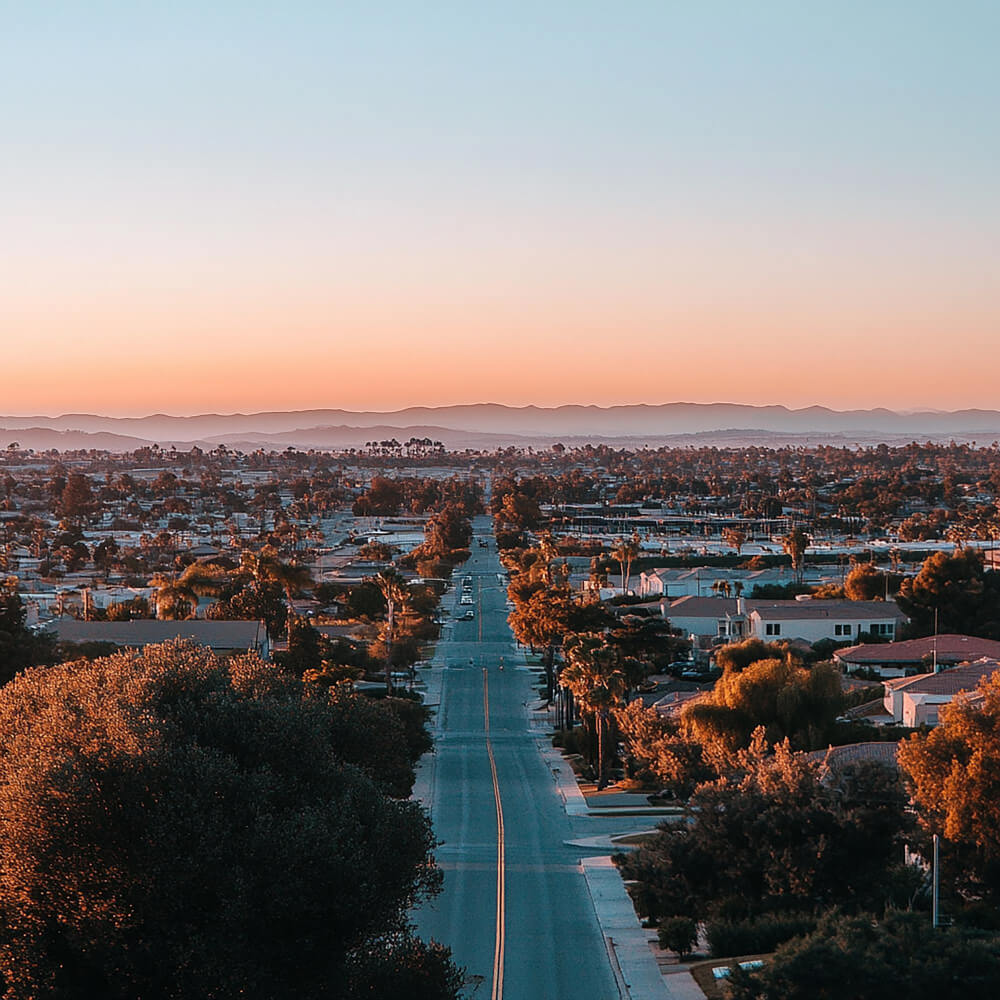 A street with a view of the horizon and a city in the distance